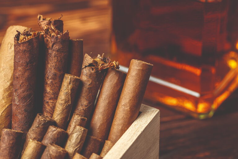 pile new cuban cigars near bottle alcohol